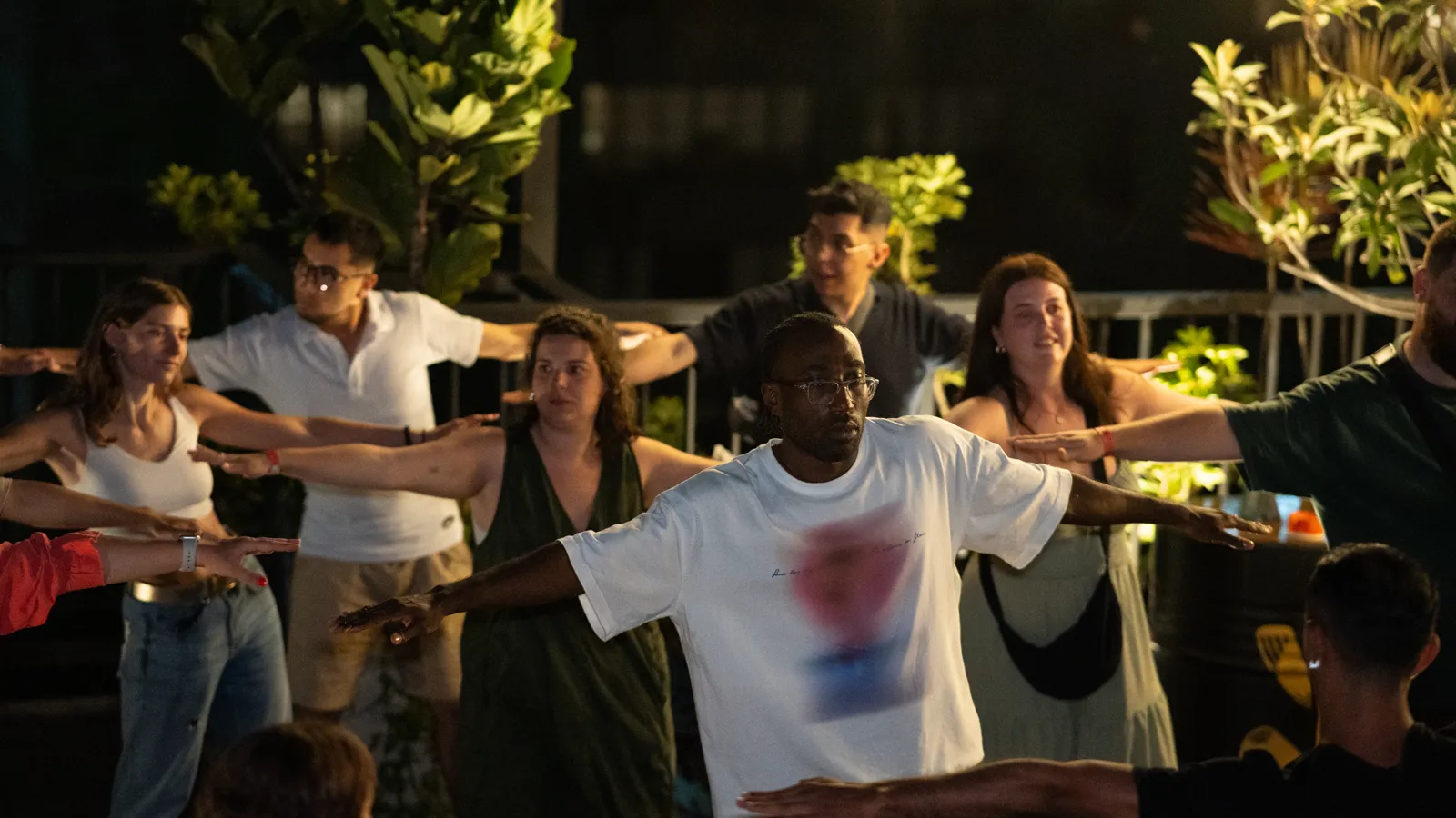 Guide leading a beginner dance class on a rooftop